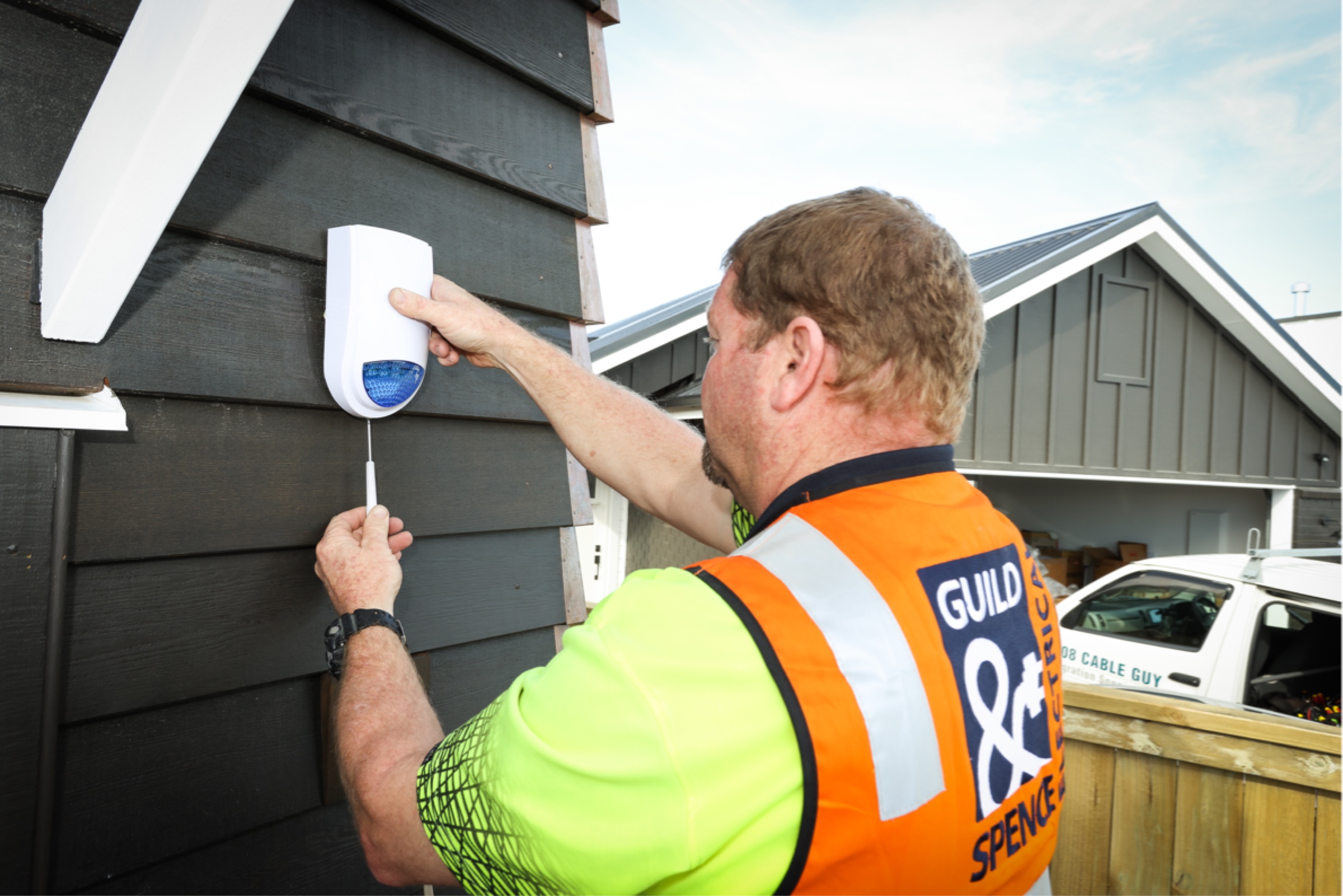 Electrician installing a security camera.