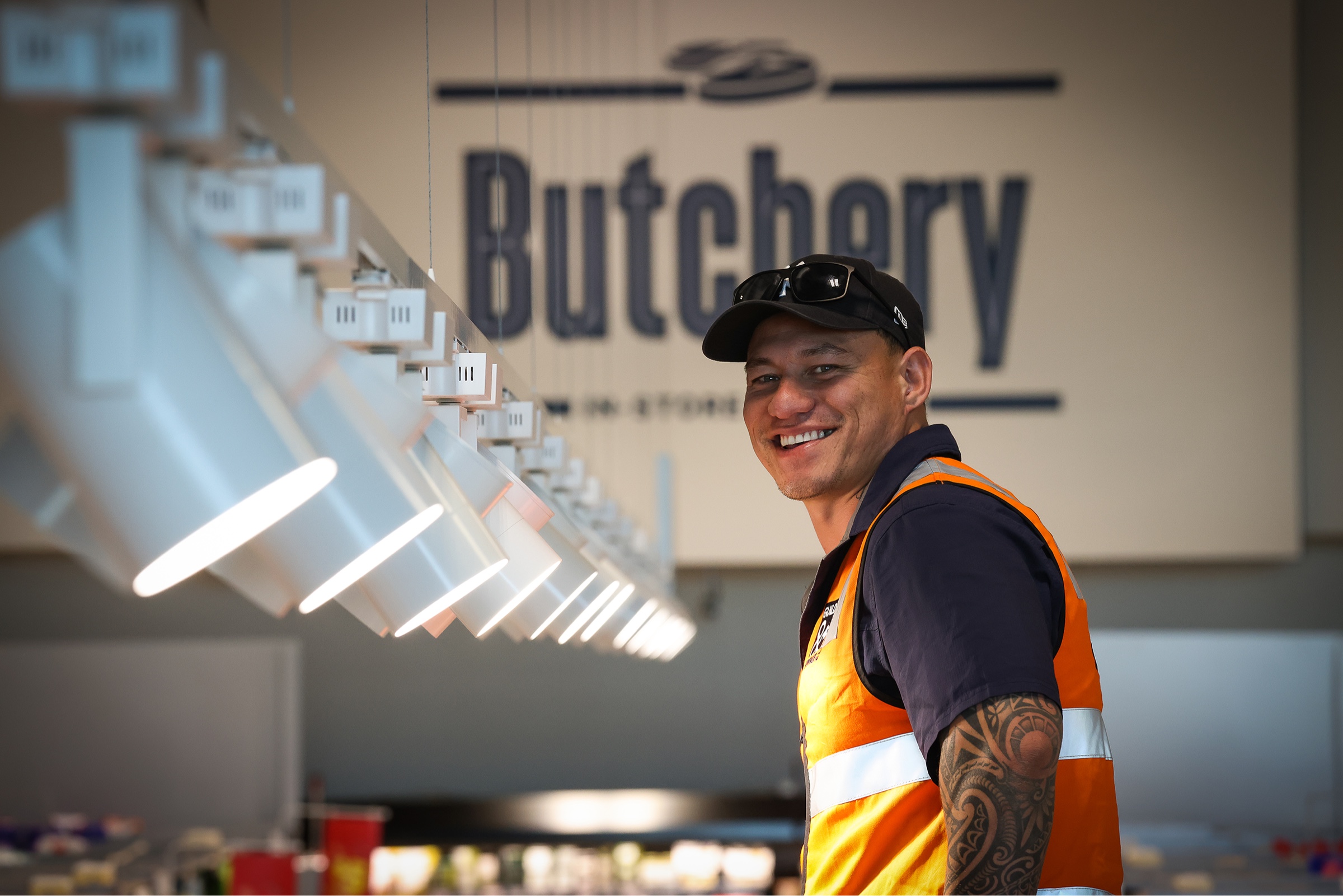 Electrician standing in front of lighting at a butchery.