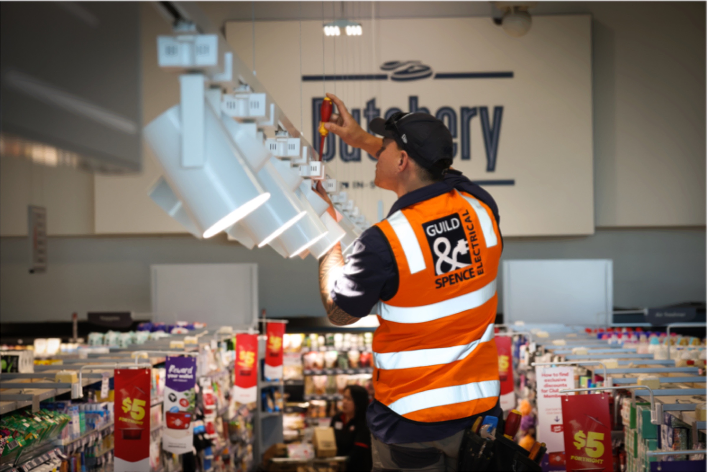 Guild & Spence electrician installing lighting at a butchery.