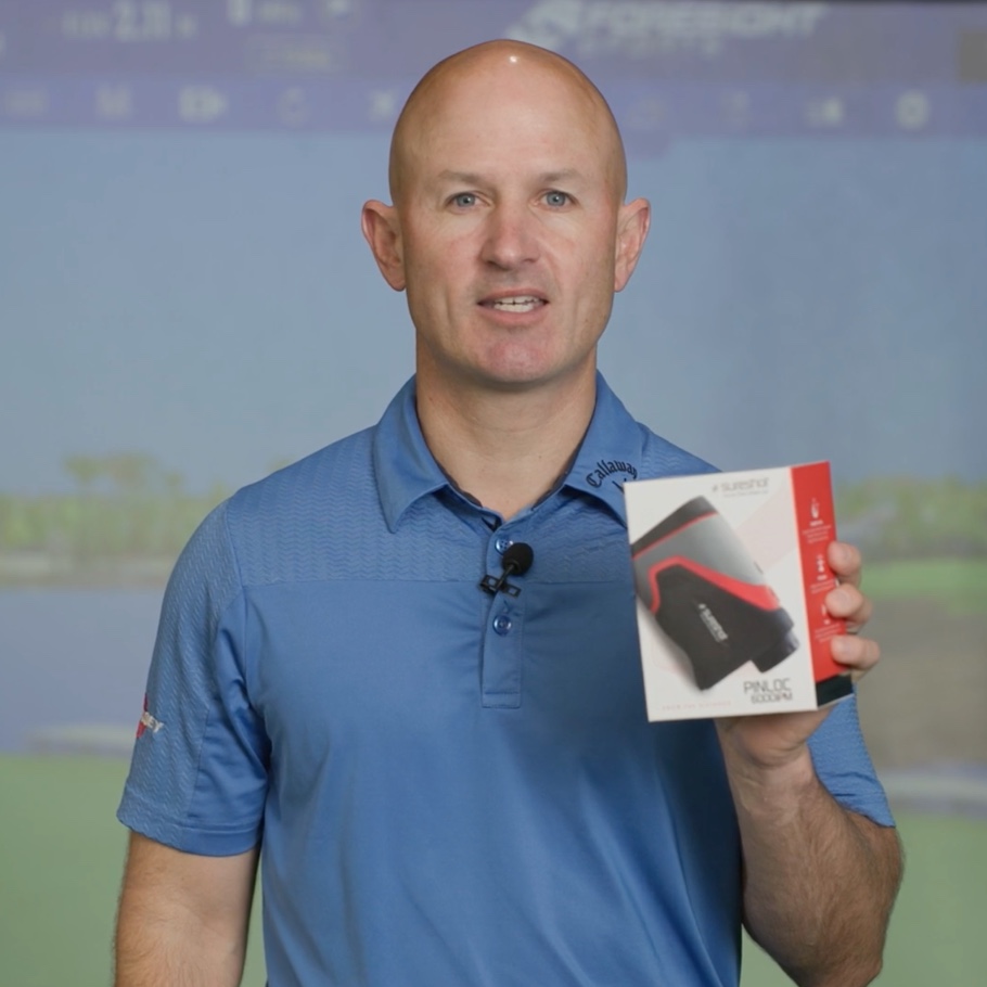 A golfer in a golf shirt holds a box.