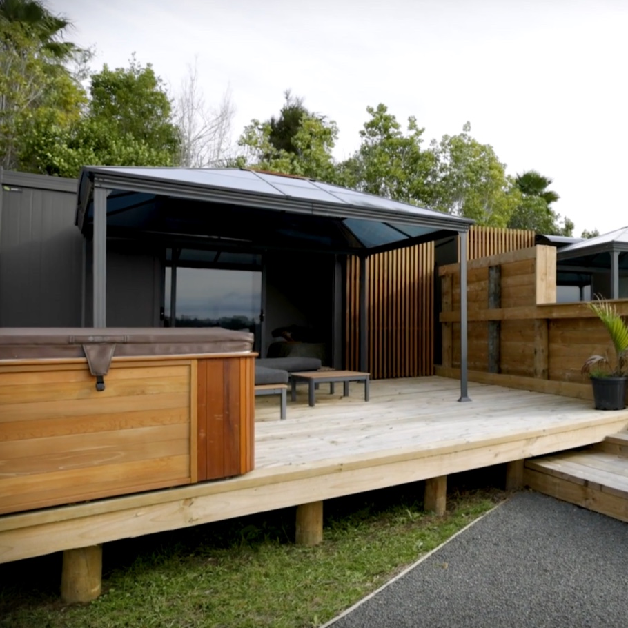A tiny home with a hot pool outside.